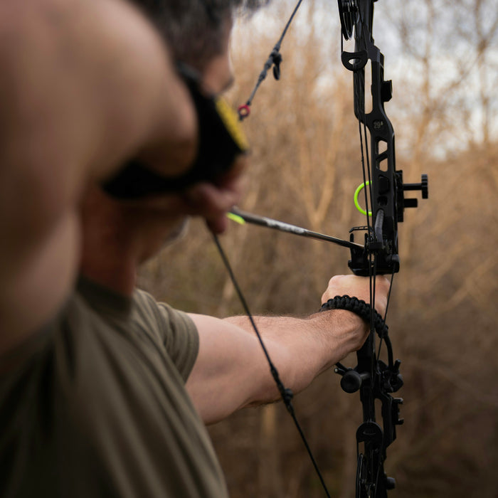 Bowhunter at full draw with a compound bow and arrow
